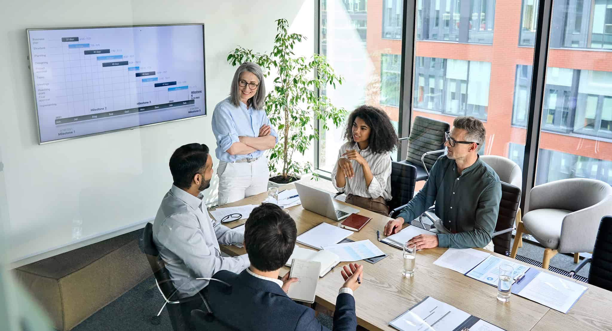 Project management professional reviewing project plans during PMP exam preparation training